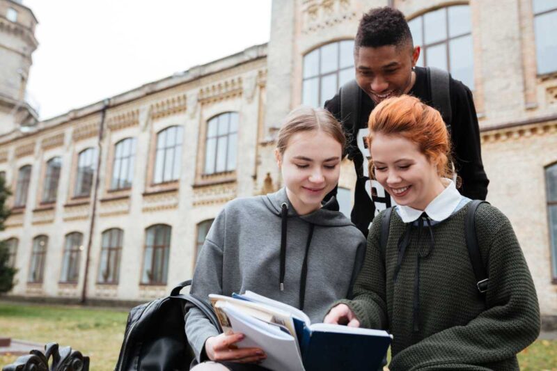 University students studying together outside a university building