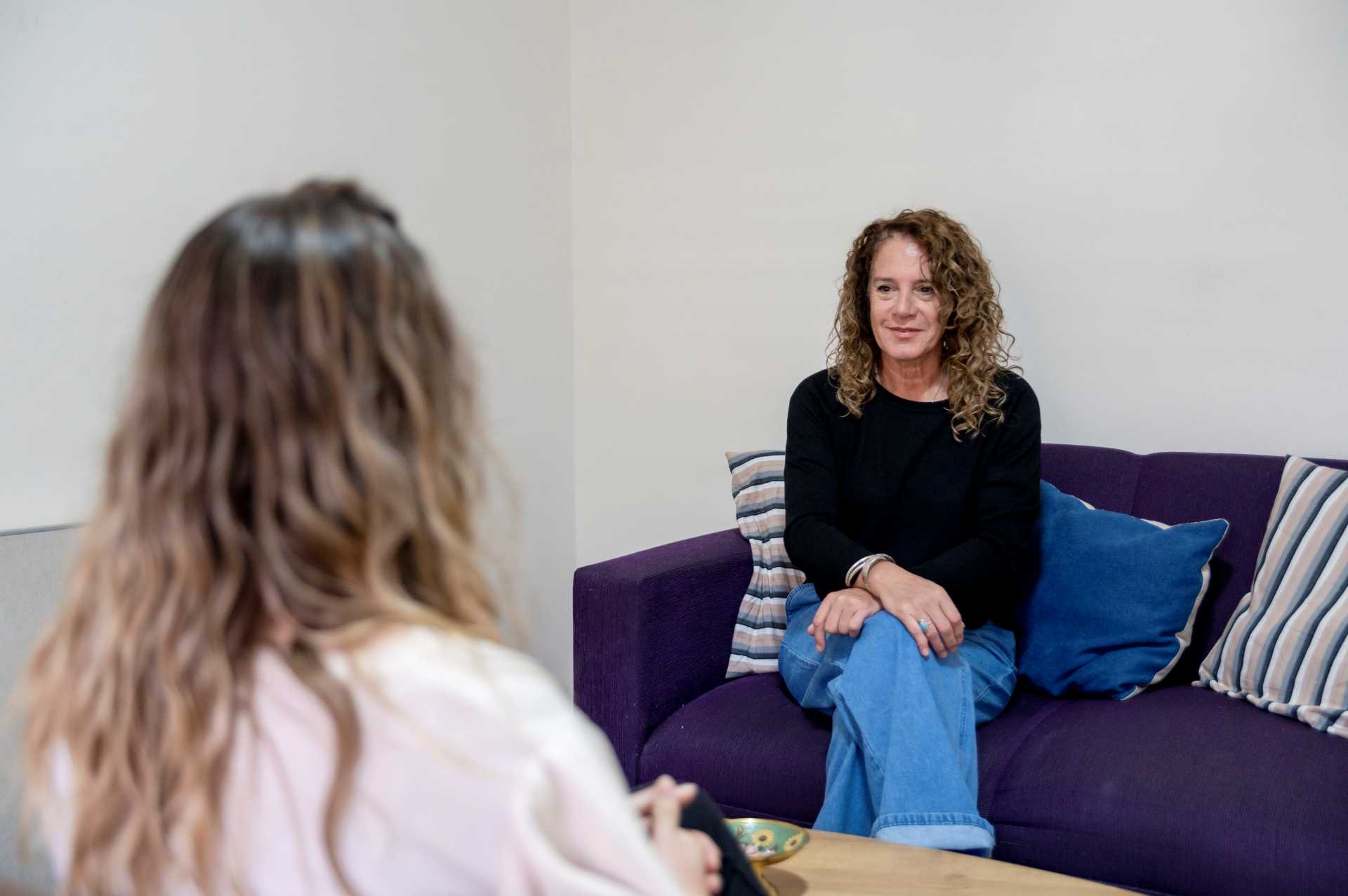 NICE compliant autism assessment, A woman sitting on a safe during a private autism assessment session.